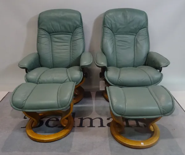 EKORNES; Three modern reclining armchairs with green leather upholstery on swivel circular bases, 76cm wide x 96cm high, with three matching footstool