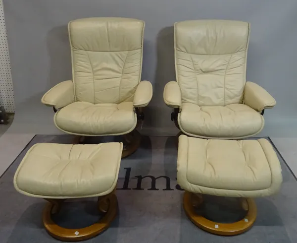 EKORNES; A pair of modern reclining armchairs with white leather upholstery on swivel circular bases, 76cm wide x 96cm high, with two matching footsto