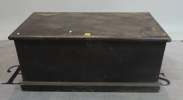 An early 20th century black painted pine trunk, 95cm wide x 44cm high.