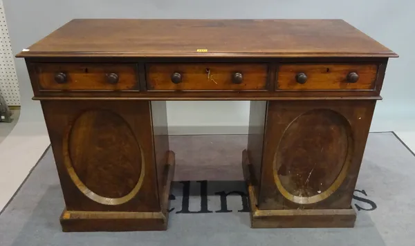 A Victorian mahogany pedestal desk with three frieze drawers over moulded panelled doors, 119cm wide x 70cm high.