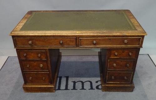A late 19th century oak pedestal desk with inset leather top over eight drawers, 122cm wide x 77cm high.