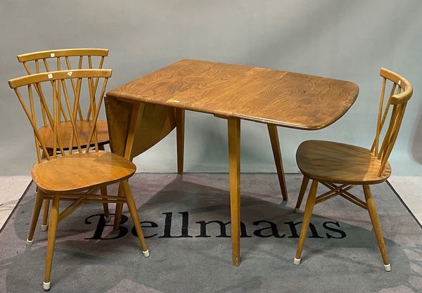 A modern Ercol oak drop flap dining table, 75cm wide x 71cm high, with three stick back dining chairs, (4).