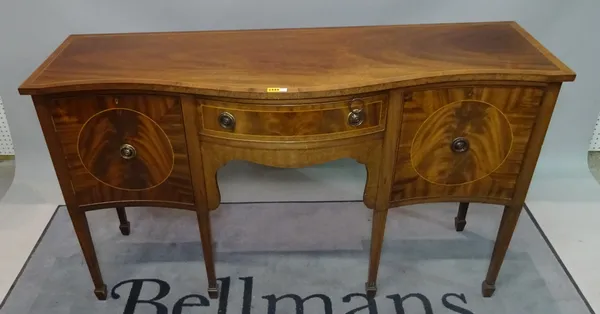 A 20th century mahogany serpentine sideboard with single drawer flanked by pair cupboards, 145cm wide x 84cm high.