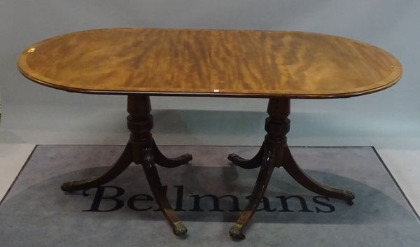 A Regency style mahogany D-end dining table with an extra leaf, 168cm long x 75cm high x 215cm long fully extended, with six Regency style mahogany di