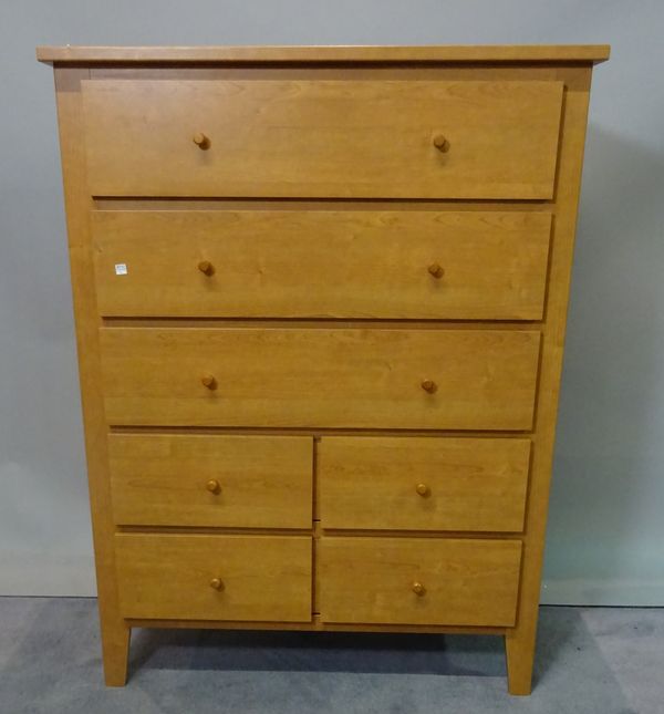 A modern hardwood tall chest with mirrored back over three long and four short drawers, 90cm wide x 120cm high.