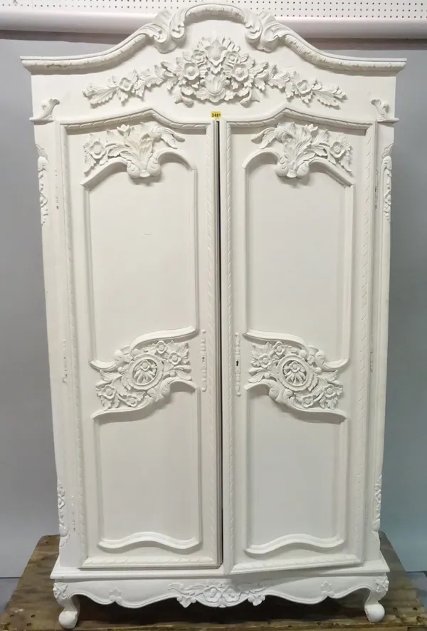 A pair of Louis XVI style white painted arch topped armoires with carved foliate decoration on cabriole supports, each 101cm wide x 202cm high.