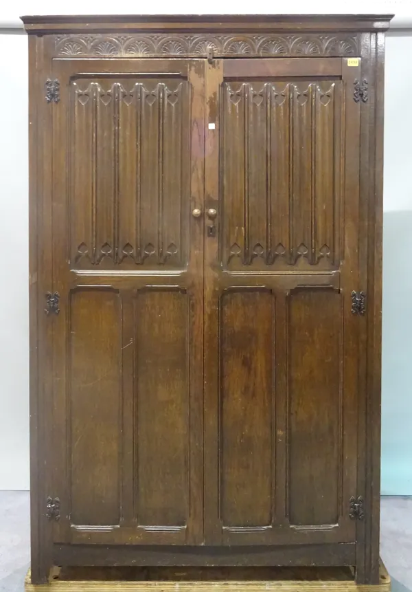 An 18th century style oak wardrobe with moulded panelled doors, 116cm wide x 181cm high.