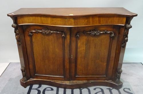 A Victorian rosewood serpentine side cabinet on a plinth base, 124cm wide x 89cm high.