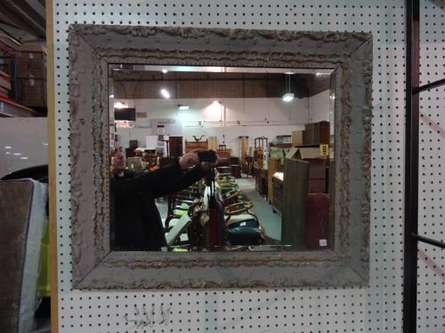 An early 20th century grey painted pine wall mirror with moulded decoration, 83cm x 72cm.