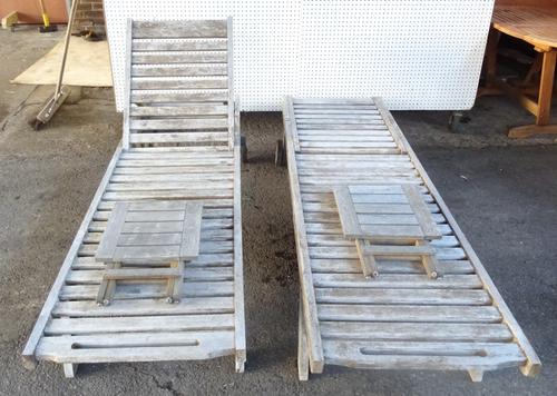 A pair of modern hardwood sun loungers with pull out tables, 62cm wide x 200cm long, (2).