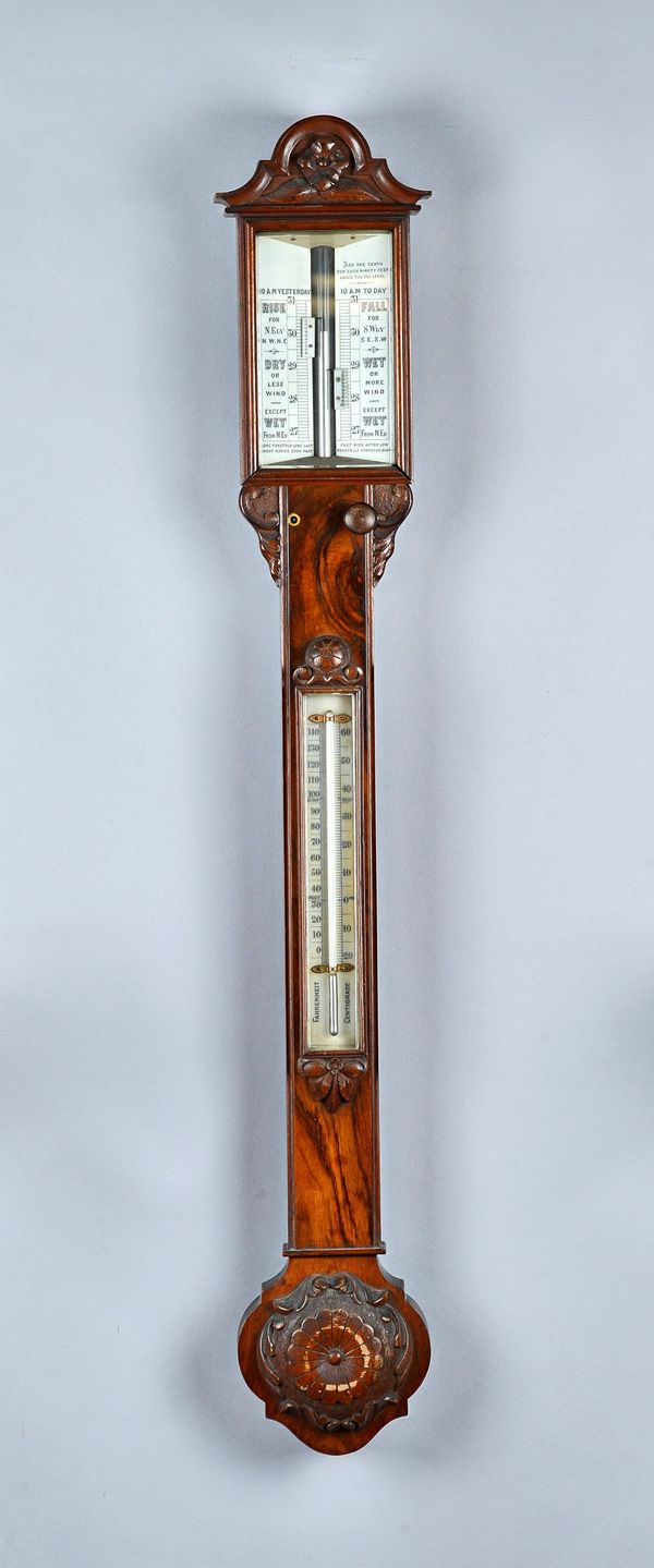 A Victorian walnut barometer  With porcelain scales and twin verniers  101cm high
