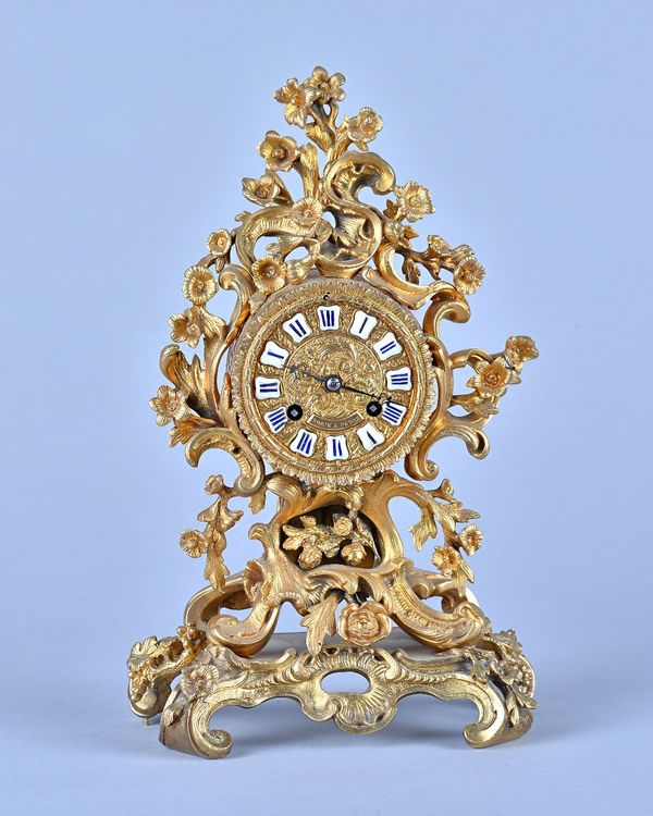 A French giltmetal mantel clockIn the Louis XV style, Circa 1870The case cast with foliate scrolls and flower heads, the dial and movement inscribed R