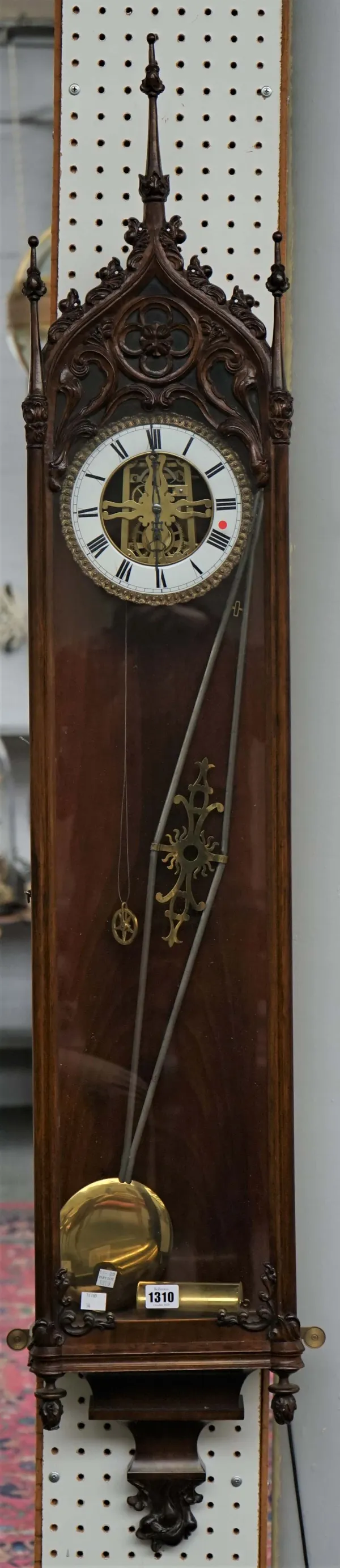 A Gothic Revival Vienna RegulatorLate 19th centuryWith skeletonised dial and plates, the steel chevron-shaped pendulum with central brass pierced pane