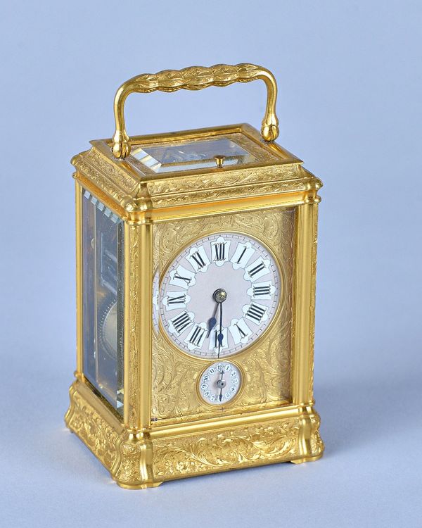 A French engraved gilt brass Gorge cased Petite Sonnerie carriage clockLate 19th CenturyWith push repeat, original platform, engraved gilt mask with l