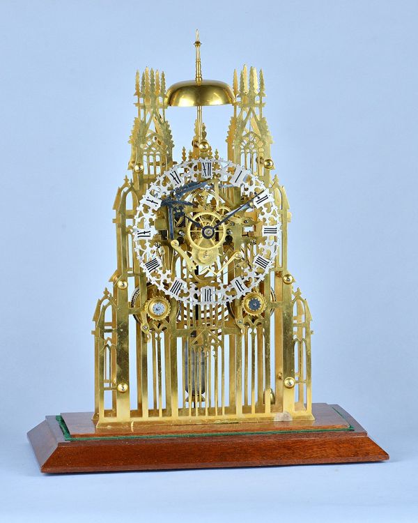 A late Victorian 'York Minster' brass Skeleton clockWith twin chain fusee movement with anchor escapement and silvered pierced chapter ring, with one-