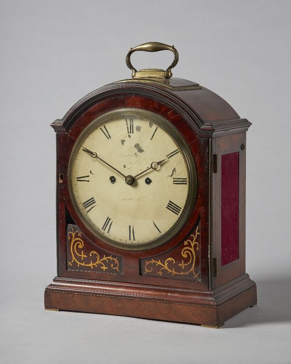 A George III brass-mounted mahogany striking bracket clockBy Williamson, Royal Exchange, LondonThe arched case with a single pad top surmounted by a b