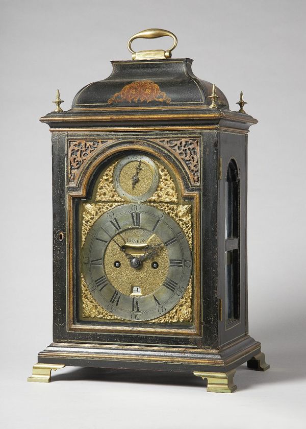 A late George III parcel-gilt, black lacquer and cream line-outlined quarter repeating striking table clockBy Nicholas Lambert, LondonThe bell-top cas