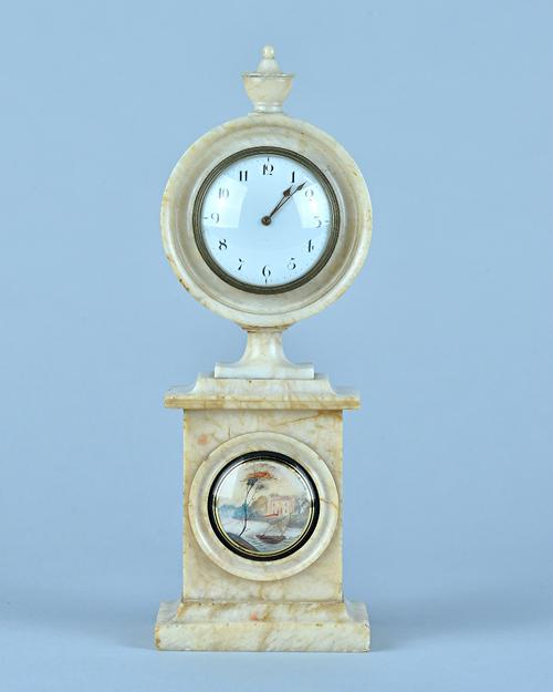 A Regency alabaster mantel timepieceSurmounted by an urn, with 2 3/4in white enamel dial, later French drum-shaped movement with platform lever escape