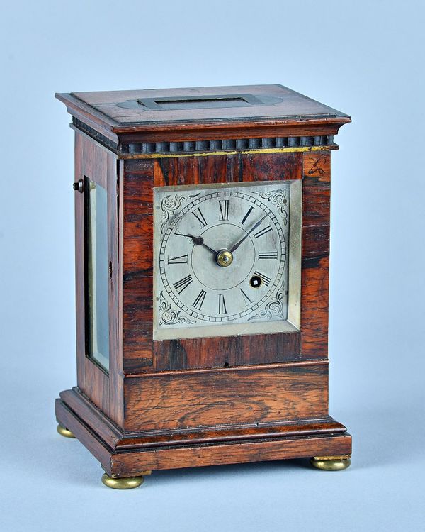 A William IV rosewood mantel timepieceThe top with inset flush carrying handle, 3in square silvered dial with chain fusee movement, anchor escapement,