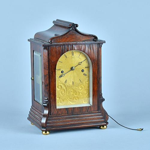 A Fine Late Regency rosewood mantel clockBy Santiago James Moore French, Royal Exchange, London The case with a swept pediment above glazed panels, th