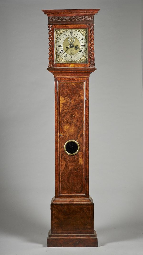 A walnut longcase clock The movement with later engraved nameThe case with a moulded pediment above blind fret, glazed door flanked by a spiral-turned