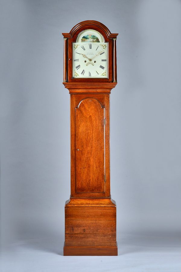 A mahogany Longcase clockEarly 19th centuryThe arched hood with two columns above the trunk door, on plinth base, the 12in arched white painted dial i