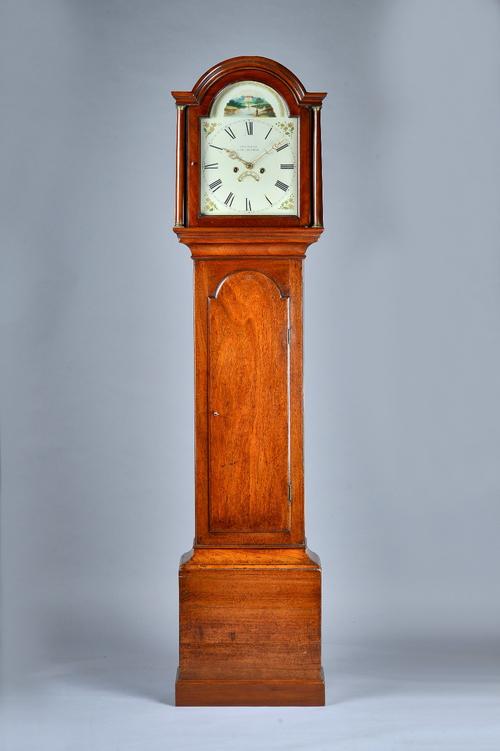 A mahogany Longcase clockEarly 19th centuryThe arched hood with two columns above the trunk door, on plinth base, the 12in arched white painted dial i