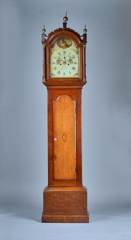 A George III oak and mahogany Longcase clockBy Robert Felmingham, StradbrookThe arched hood with shaped cresting, three finials, flanked by fluted col