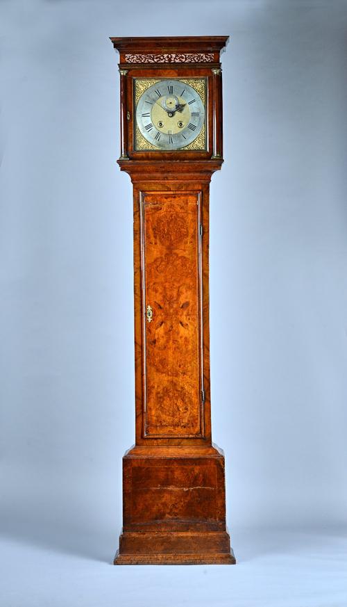 A Queen Anne walnut Month-going Longcase  clockThe movement by Windmills, LondonThe hood with moulded pediment, above three-quarter columns, the trunk