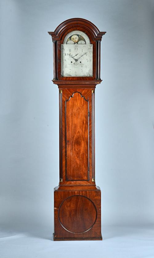 A George III mahogany Longcase clockBy William Curtis, ExeterThe arched hood with moulded pediment above fluted columns, the trunk with an arched door
