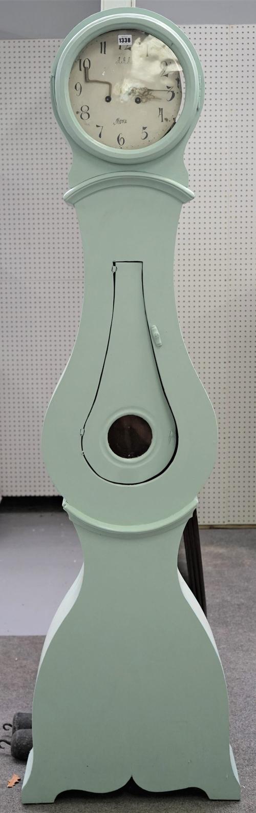 A Swedish longcase clock, green painted with circular hood and white painted dial detailed 'A.A.S. Mora' with twin train movement over a shaped case,