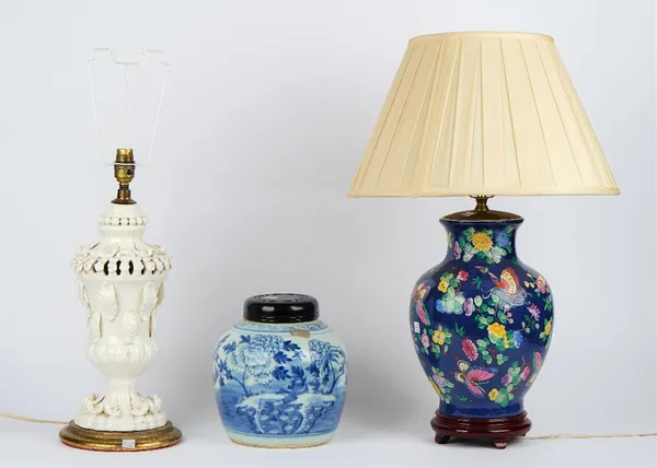 A white glazed pottery table lamp on a circular gilt painted base, 44cm high, a blue ground ceramic baluster table lamp decorated with butterflies, 36