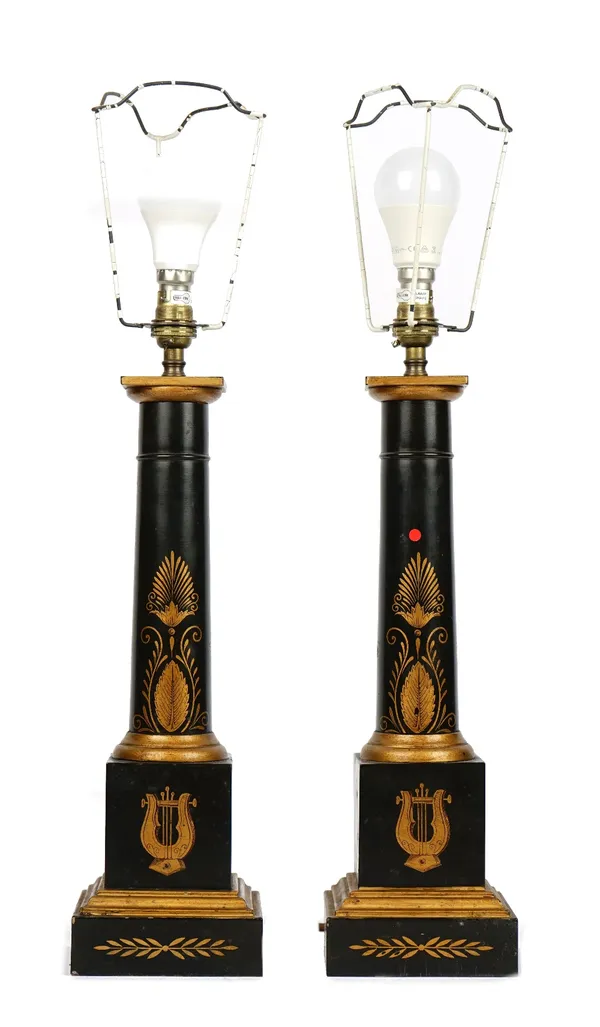 A pair of modern tôle peinte table lamps, of columnar form, gilt painted with cornucopia and anthemion against a dark ground, 40cm high, with shades.