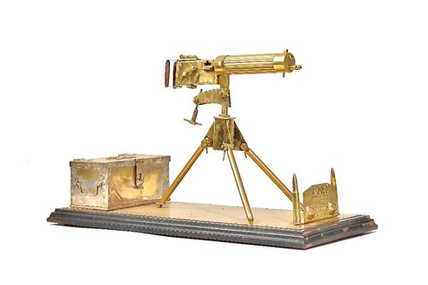 A brass model of a WWI Vickers machine gun, 20th century, with separate hinged ammunition chest and applied plaque detailed' MCG PTE W.T Reave R.F.A.