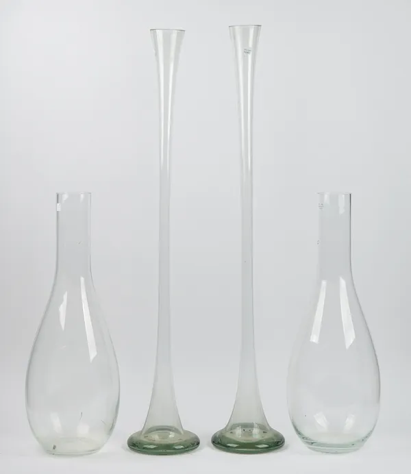 A near pair of large clear glass specimen vases of tapering form, early 20th century, 98cm and 97cm high, and a smaller pair of slender pear-shaped fo