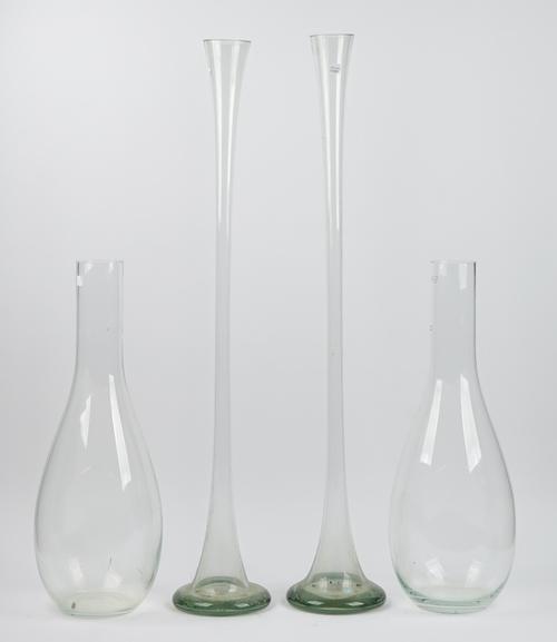 A near pair of large clear glass specimen vases of tapering form, early 20th century, 98cm and 97cm high, and a smaller pair of slender pear-shaped fo
