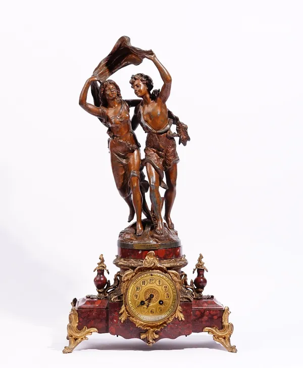 After Bruchon, a French figural spelter and rouge marble mantel clock, circa 1900, with a plaque inscribed ' L'ORAGE par Bruchon, pendulum and key, 64