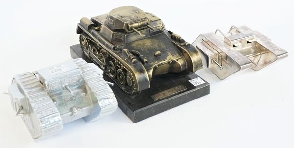 A chrome plated white metal novelty inkwell modelled as a WWI British Mark IV tank, 20th century, with hinged lid, 150cm wide, and two further metal m