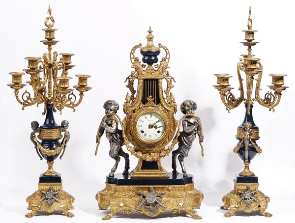 An Louis XVI style gilt metal mounted clock garniture, 20th century, the clock having a white painted dial detailed IMPERIAL MADE IN ITALY and the mov