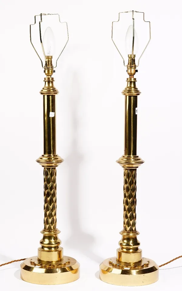 A large pair of modern gilt bronze table lamps, of columnar form, 68cm high, with shades.