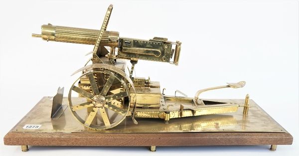 A brass model of a WWI Vickers machine gun, 20th century, the base with titled plaque 'France Belgium Machine Gun Corps', on a mahogany plinth and six