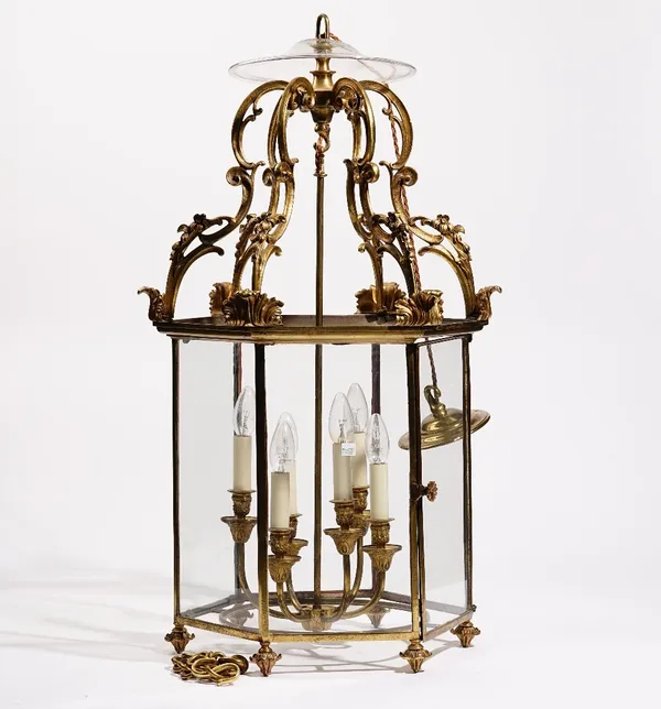 A George III style gilt metal, glazed hall lantern, of hexagonal form, with later internal six light pendant, Second half of the 19th century, 88cm hi