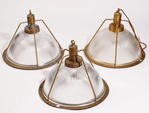 A set of three modern brass and holophane glass industrial ceiling lights, 34cm high (3).