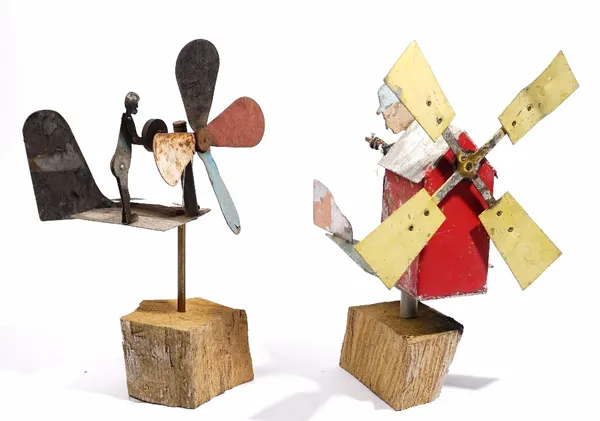 Two primitive/folk art whirlygigs both modelled as a person cranking a windmill, approx 35cm high.