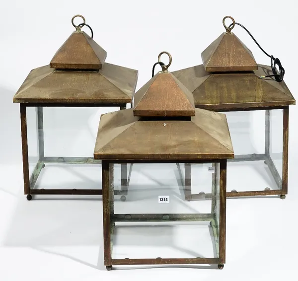 A set of three modern square copper glazed lanterns, 63cm high (3).