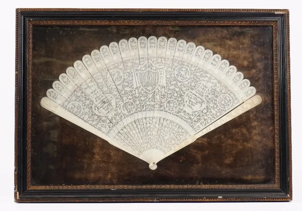 A Canton export ivory brise fan, late 18th century, the sticks carved with vases, flowerheads, birds and a central shield shaped cartouche with a mono