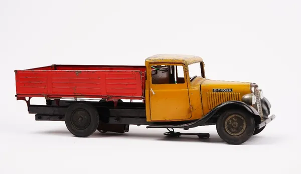 A tinplate model of a Citroen flatbed truck, probably French, Circa 1930, finished in red and yellow, with a winding key, length 47cm.