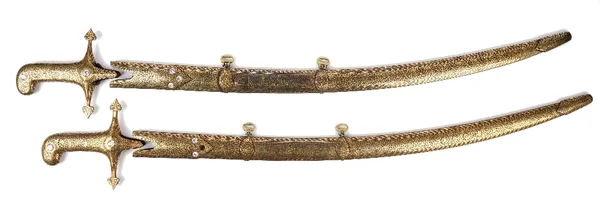 Two Islamic gold damascened steel sword scabbards, length 93cm and two hilts, 20th century, with Arabic inscriptions and set with white colourless pas