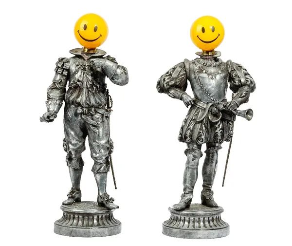 A pair of novelty silvered metal figures, modelled as a pair of Cavaliers with later Acid House emblem heads, 60 cm high.