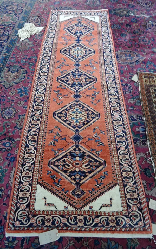 A Sarough runner, Persian, the madder field with fine indigo diamonds, ivory spandrels, each with a duck; a flower, leaf and vine border, 265cm x 82cm